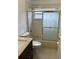 This bathroom features a shower-tub combo with glass doors, toilet, and modern vanity at 9003 Pecky Cypress Way, Orlando, FL 32836