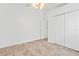 Bedroom with tile floor, ceiling fan, closet, and access to adjacent living space at 9003 Pecky Cypress Way, Orlando, FL 32836