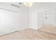 Bedroom with tile floor, ceiling fan, and access to a walk-in closet and adjacent living space at 9003 Pecky Cypress Way, Orlando, FL 32836