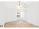 Bright bedroom featuring tiled floors, a ceiling fan, and a spacious closet for ample storage at 9003 Pecky Cypress Way, Orlando, FL 32836