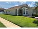 Beautiful home with a lush green lawn and meticulous landscaping at 9003 Pecky Cypress Way, Orlando, FL 32836