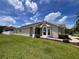 Well-maintained home with lush green lawn and neat landscaping on a sunny day with blue skies and clouds at 9003 Pecky Cypress Way, Orlando, FL 32836