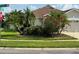 Well-maintained corner lot with mature landscaping, including palm trees at 9003 Pecky Cypress Way, Orlando, FL 32836