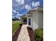 Inviting entrance with a brick walkway, bay window, and manicured shrubs at 9003 Pecky Cypress Way, Orlando, FL 32836