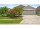 Charming single-story home with a paver driveway and colorful landscaping at 9003 Pecky Cypress Way, Orlando, FL 32836
