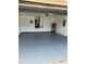 Spacious garage with epoxy floor coating, water heater, and air conditioning unit at 9003 Pecky Cypress Way, Orlando, FL 32836