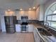 Bright kitchen with stainless steel appliances, granite countertops, and plenty of cabinet space at 9003 Pecky Cypress Way, Orlando, FL 32836