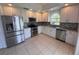 Modern kitchen featuring stainless steel appliances, granite countertops, and white cabinets at 9003 Pecky Cypress Way, Orlando, FL 32836