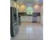 Bright kitchen with stainless steel appliances, white cabinets, and tile backsplash at 9003 Pecky Cypress Way, Orlando, FL 32836