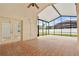 This enclosed lanai has a ceiling fan and opens to the backyard through glass doors at 9003 Pecky Cypress Way, Orlando, FL 32836