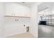 Bright laundry room with overhead cabinets and tile flooring at 9003 Pecky Cypress Way, Orlando, FL 32836