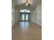 Spacious living room with tile flooring and doors leading to the exterior at 9003 Pecky Cypress Way, Orlando, FL 32836