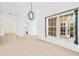 Bright living room with tiled floors, neutral walls, and abundant natural light from large windows at 9003 Pecky Cypress Way, Orlando, FL 32836