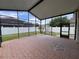 Screened-in patio featuring ceramic tile flooring, offering an ideal space for relaxation and entertainment at 9003 Pecky Cypress Way, Orlando, FL 32836