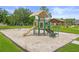Community playground featuring swings, slide and shaded seating at 9003 Pecky Cypress Way, Orlando, FL 32836