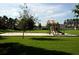 A great community playground sits in the manicured lawn at 9003 Pecky Cypress Way, Orlando, FL 32836