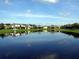 Scenic view of the pond reflecting the surrounding community homes at 9003 Pecky Cypress Way, Orlando, FL 32836