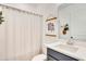 Bright bathroom featuring a shower with a neutral-toned shower curtain and a stylish vanity with modern fixtures at 913 Sabal Breeze Ln, Apopka, FL 32703