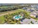 Aerial view of the community pool with palm trees, lounge chairs, playground, and parking area at 913 Sabal Breeze Ln, Apopka, FL 32703