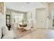 Inviting dining room with a rustic wooden table, six chairs, and neutral decor at 913 Sabal Breeze Ln, Apopka, FL 32703