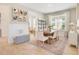 Bright dining room with a wooden table, six chairs, a decorative rug, and natural light at 913 Sabal Breeze Ln, Apopka, FL 32703