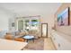 Bright living room with a comfortable sectional sofa, stylish decor, and a large window overlooking the backyard at 913 Sabal Breeze Ln, Apopka, FL 32703