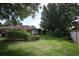 Lush backyard featuring mature trees, manicured shrubs, and green grass providing a serene outdoor space at 9206 Everwood St, Orlando, FL 32825