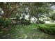 Spacious backyard with lush lawn, mature trees, and privacy fence at 9206 Everwood St, Orlando, FL 32825