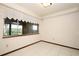 Bedroom featuring tile floor and a window with lace curtain at 9206 Everwood St, Orlando, FL 32825