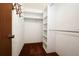 Walk-in closet with a rod for hanging clothes and shelving for storage at 9206 Everwood St, Orlando, FL 32825