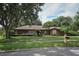 Inviting single-story home with lush landscaping and a well-maintained lawn at 9206 Everwood St, Orlando, FL 32825