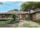 Charming home featuring stone accents, a walkway, and lush landscaping at 9206 Everwood St, Orlando, FL 32825