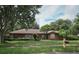 Charming single-story home with stone accents, mature trees, and well-maintained landscaping at 9206 Everwood St, Orlando, FL 32825