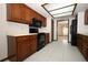 Kitchen featuring wood cabinets, white countertops, and black appliances at 9206 Everwood St, Orlando, FL 32825