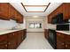 Functional kitchen with wood cabinets, white countertops, and black appliances at 9206 Everwood St, Orlando, FL 32825