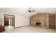 Bright living room with a brick fireplace, tile floors, and ceiling fan at 9206 Everwood St, Orlando, FL 32825
