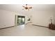 Bright living room with tile floors, a ceiling fan, and sliding glass doors at 9206 Everwood St, Orlando, FL 32825