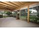 Large screened-in patio with wood ceiling beams and view of the landscaped backyard at 9206 Everwood St, Orlando, FL 32825