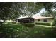 Back exterior view showcasing the screened-in patio and well-maintained yard at 9206 Everwood St, Orlando, FL 32825