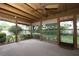 Enclosed sunroom with views of the landscaped backyard through large windows at 9206 Everwood St, Orlando, FL 32825