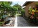 Outdoor pathway with a bench and lush foliage, leading to a private backyard area at 9206 Everwood St, Orlando, FL 32825