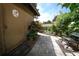 Stone walkway surrounded by lush foliage and a bench with a small 'Love' decoration on the house at 9206 Everwood St, Orlando, FL 32825