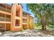Condo exterior with balconies and stairs, set by a lake and trees at 958 Salt Pond Pl # 103, Altamonte Springs, FL 32714