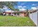Expansive backyard features a well-maintained lawn and a privacy fence, perfect for outdoor activities at 978 Calanda Ave, Orlando, FL 32807
