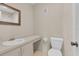 Cozy bathroom featuring a vanity with sink, toilet, and a mirror, offering a functional space at 978 Calanda Ave, Orlando, FL 32807