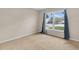 Bright bedroom with neutral carpet, large window with sheer curtains, and ample natural light at 978 Calanda Ave, Orlando, FL 32807