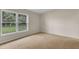 Cozy bedroom with carpet flooring, a large window, and neutral walls at 978 Calanda Ave, Orlando, FL 32807