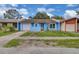 Charming single-Gathering home showcasing a light blue exterior with an attached one-car garage and cozy front yard at 978 Calanda Ave, Orlando, FL 32807