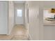 Bright hallway with neutral walls, tile flooring, and decorative floor medallion leading to a well-lit entryway at 978 Calanda Ave, Orlando, FL 32807