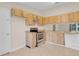 Traditional kitchen featuring wood cabinetry, stainless steel range, and ceramic tile flooring at 978 Calanda Ave, Orlando, FL 32807